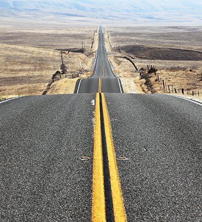 The road goes the distance. Perfectly smooth highway across the endless desert